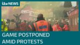 Manchester United's game postponed after fans storm pitch | ITV News